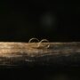 elegant gold wedding rings on rustic wood