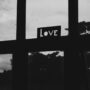 grayscale photo of a love sign on a window
