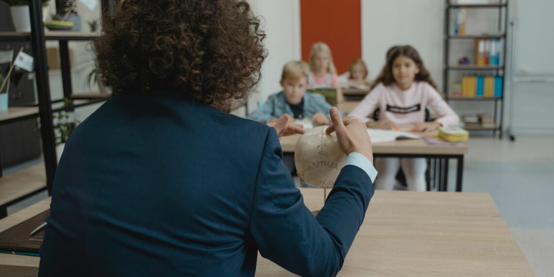 teacher showing class a human skull