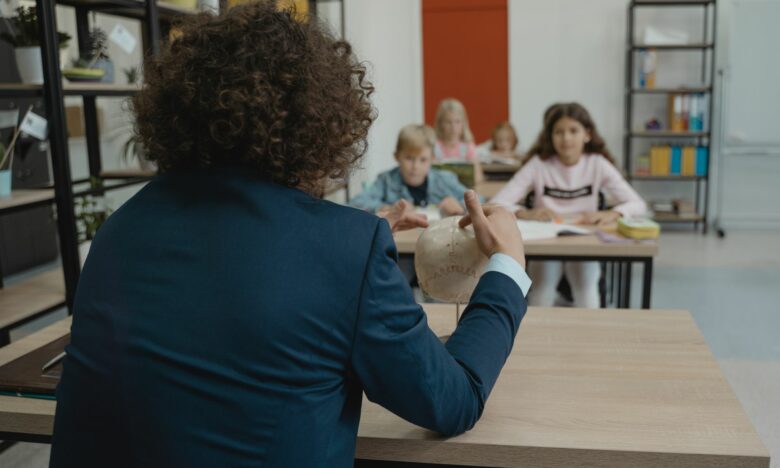 teacher showing class a human skull