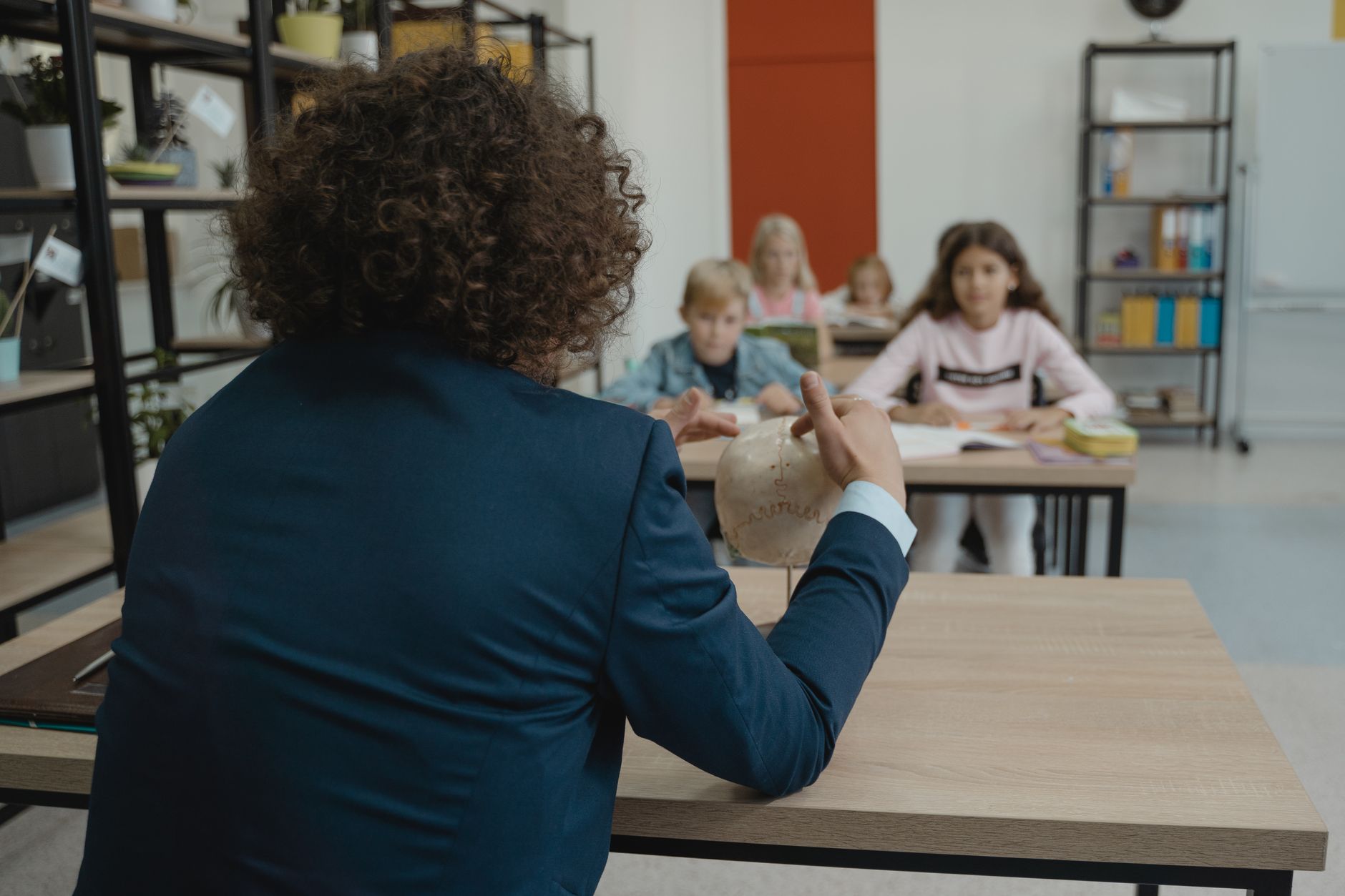 teacher showing class a human skull
