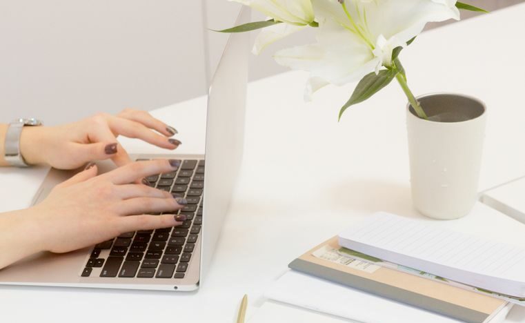 a person typing on the laptop