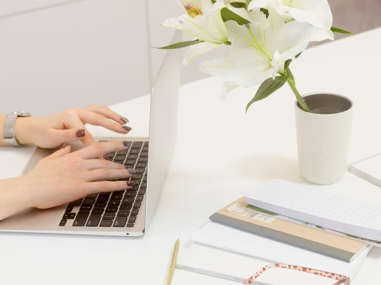 a person typing on the laptop