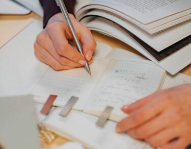 person writing on white paper