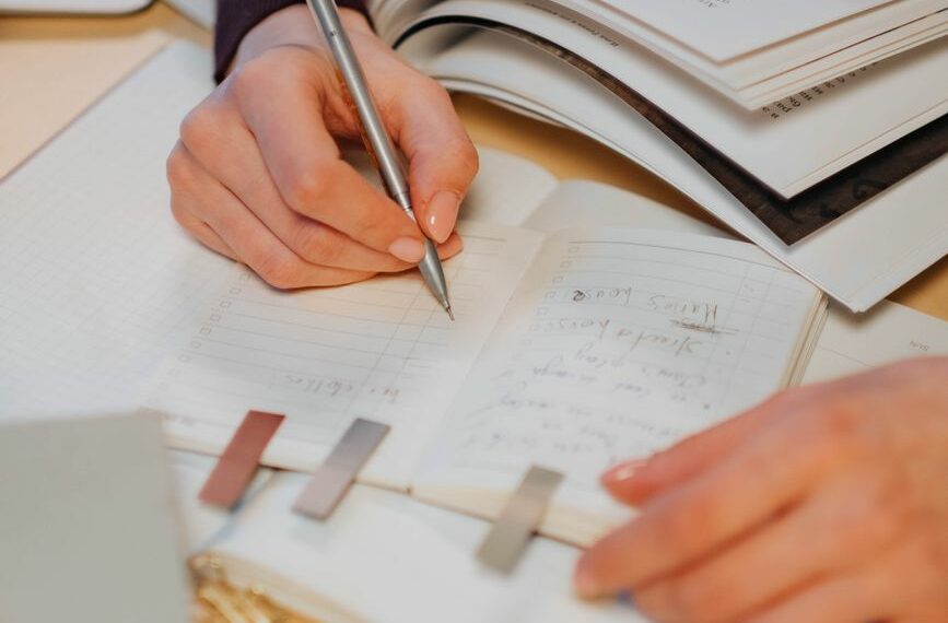 person writing on white paper
