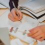 person writing on white paper